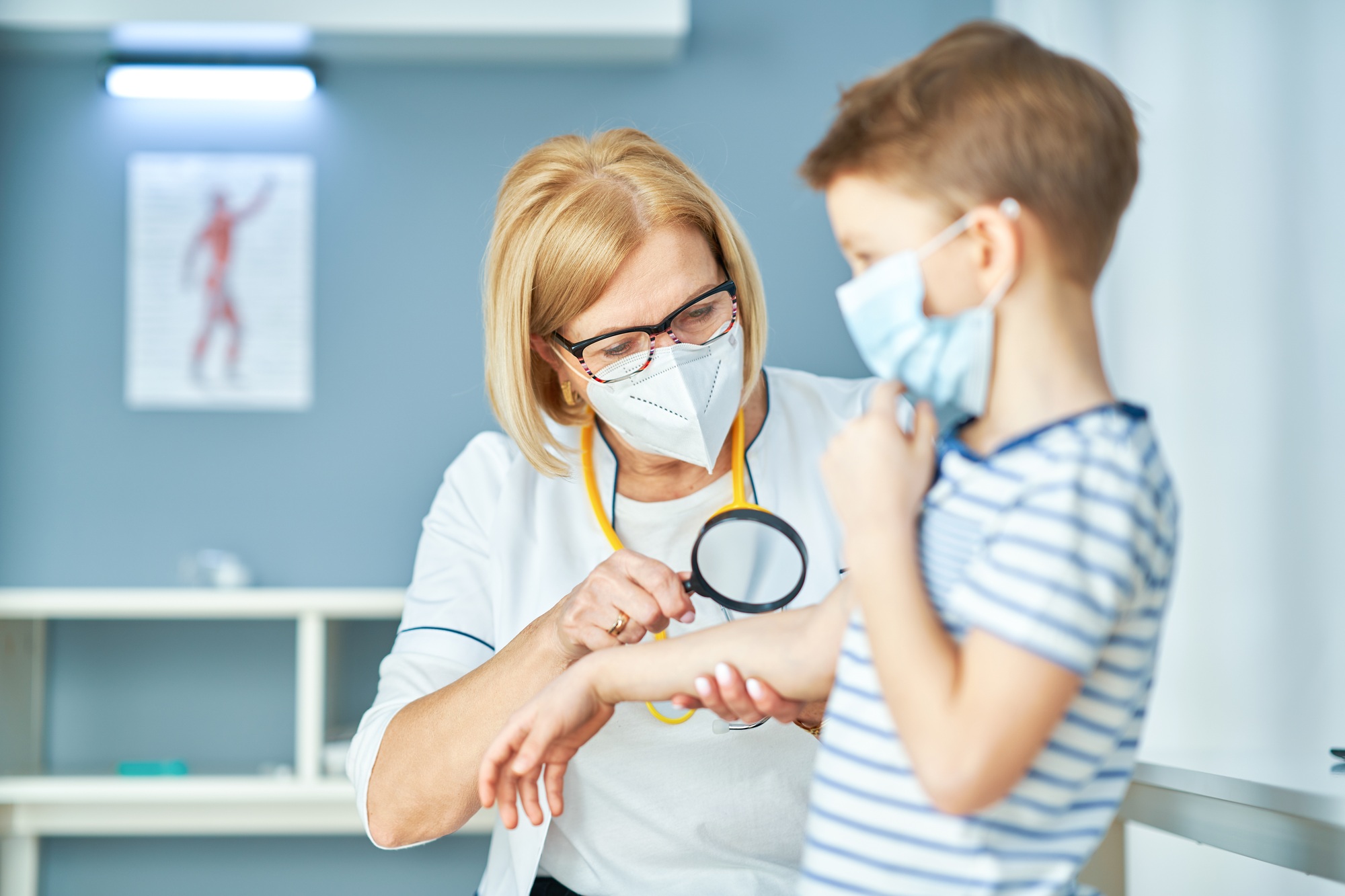 Pediatrician doctor examining little kids in clinic